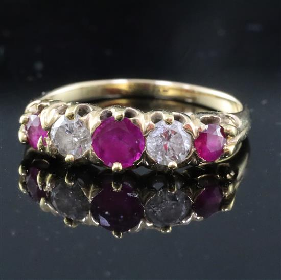 A gold, three stone ruby and two stone diamond set half hoop ring, size M